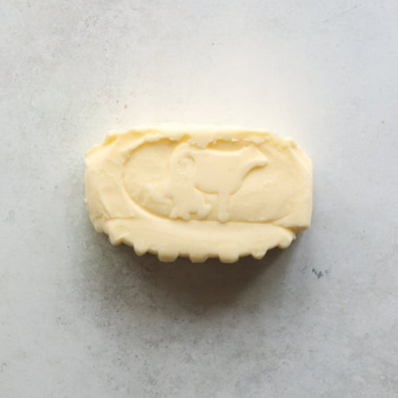 French butter from FINE & WILD, 125g oval block with cow imprint, churned in wooden barrels.