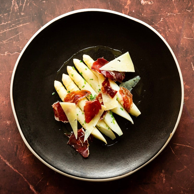 Cooked 'La Delicate' White Asparagus served with cured ham and cheese, showcasing premium seasonal produce | FINE & WILD UK gourmet vegetables